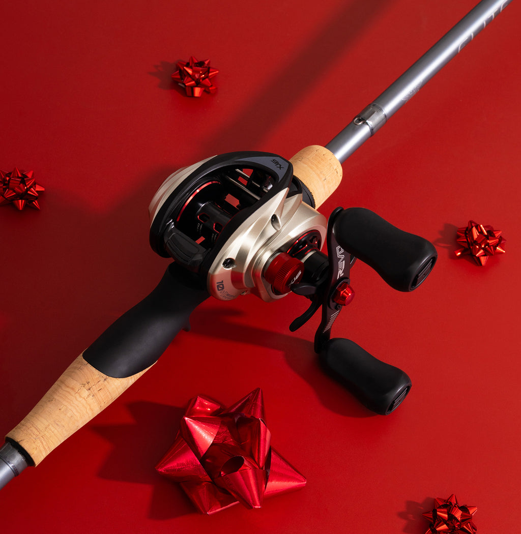 Fishing rod with reel on a red background with decorative bows