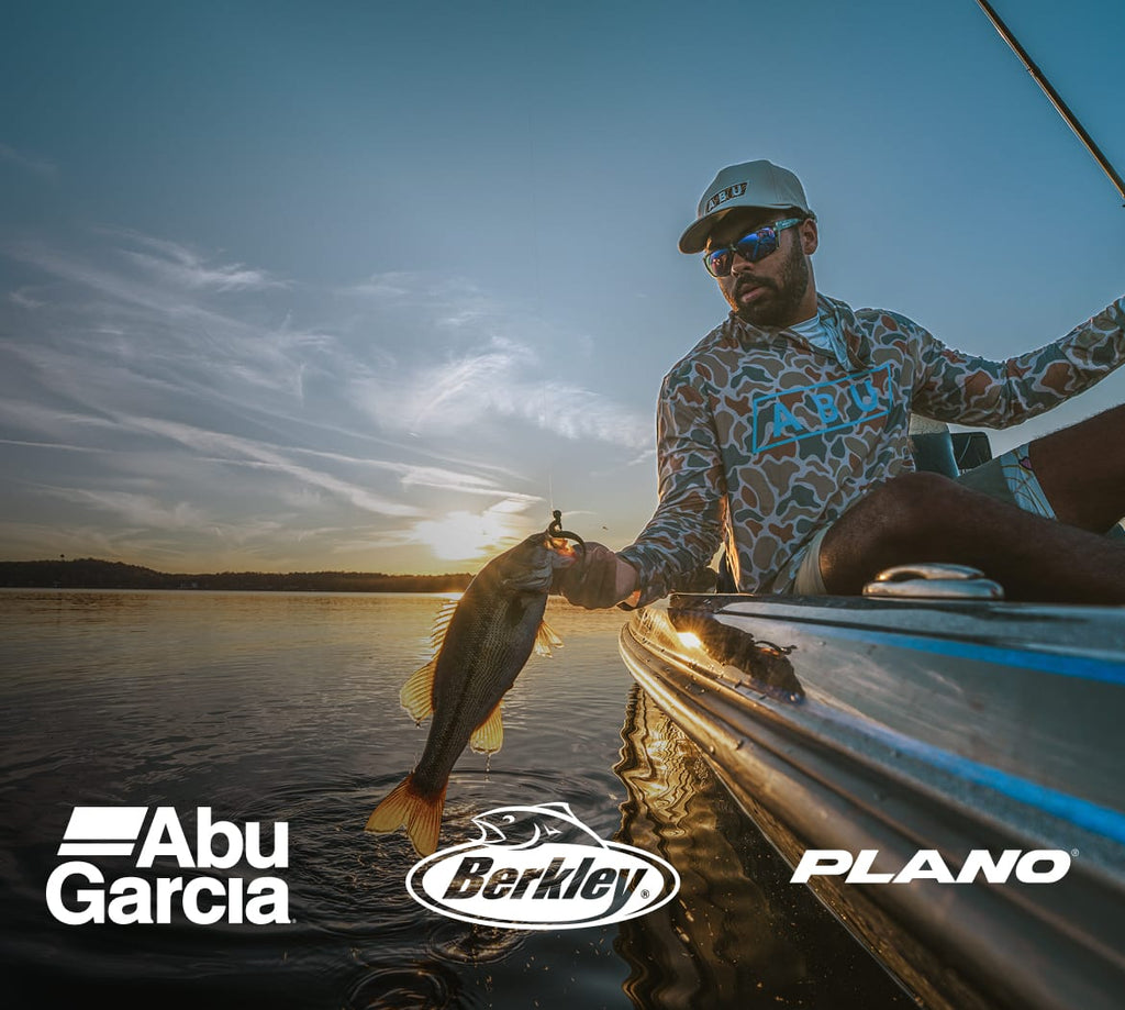 Man on a boat holding a fish with Abu Garcia, Berkley, and Plano logos.