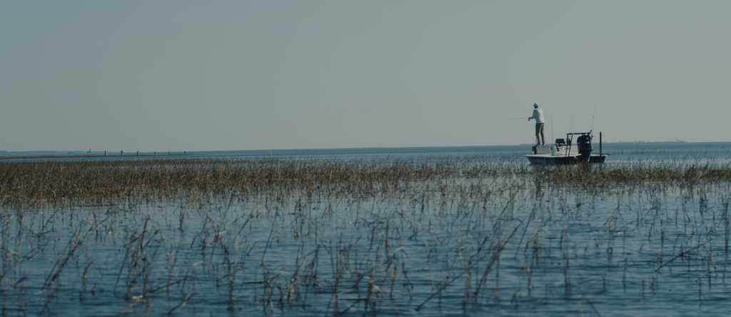 Man fishing on a boat in the flats